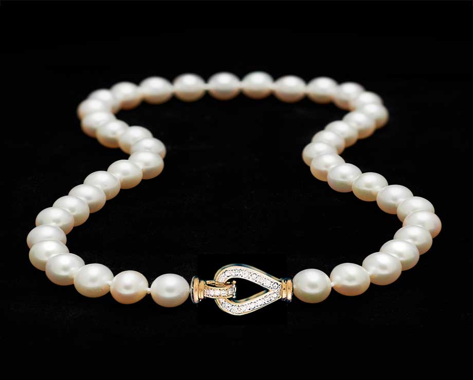 A Strand Of 8 MM Cultured Pearls With Diamond Clasp